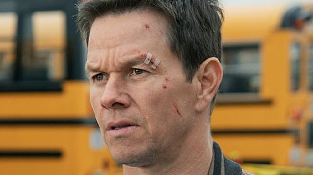 Mark Wahlberg as Spenser in school bus parking lot in Spenser Confidential