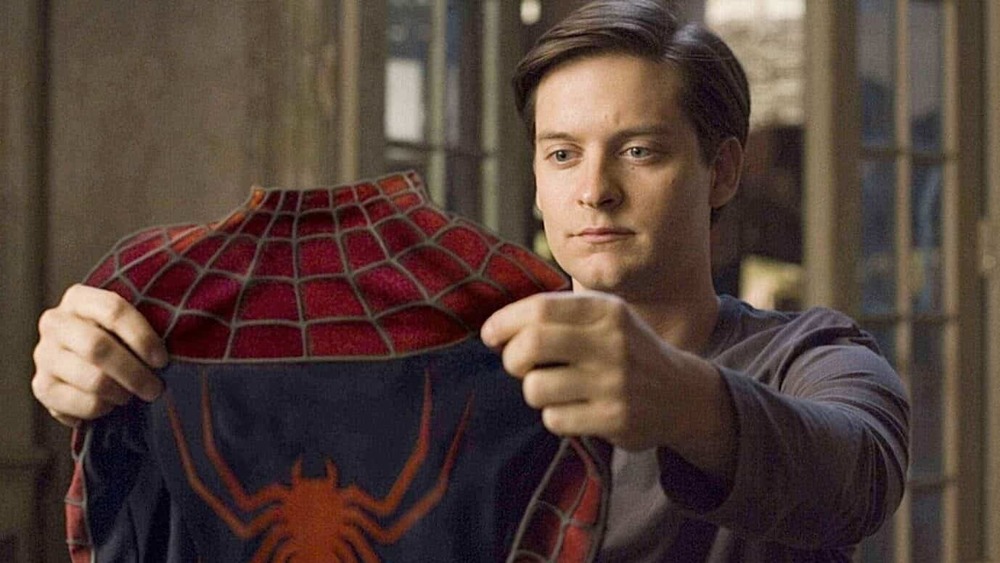 Tobey Maguire holding spider-suit