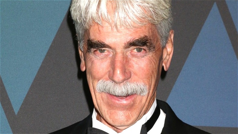 Sam Elliott smiling for press