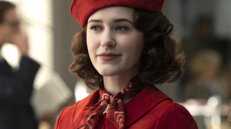 Midge Maisel wears a red hat