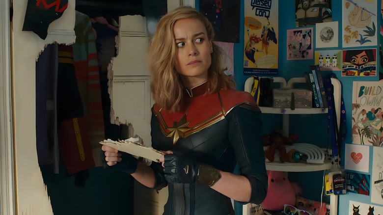 Captain Marvel holding broken door