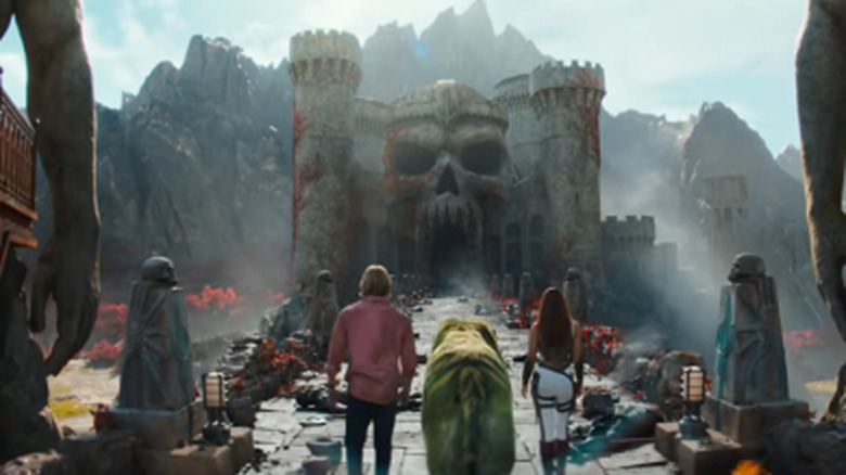 Adam, Battlecat, and Teela walking toward Castle Greyskull on Masters of the Universe (2026)