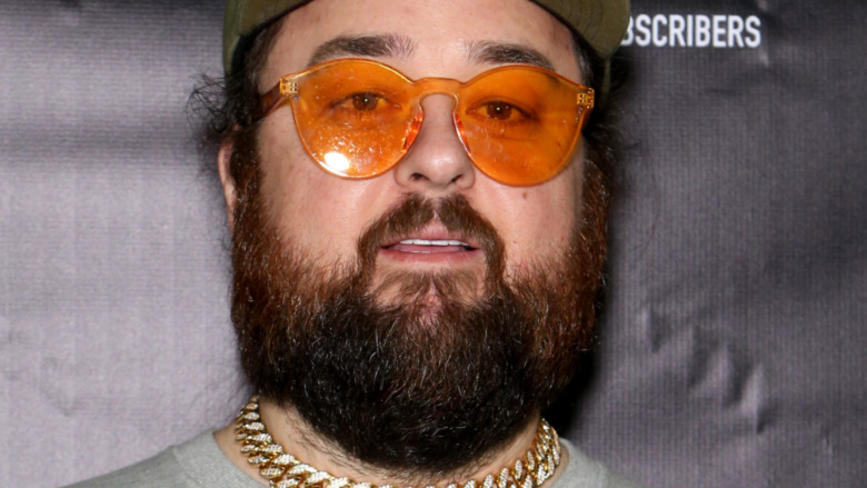 Chumlee sporting a full beard and orange tinted glasses 