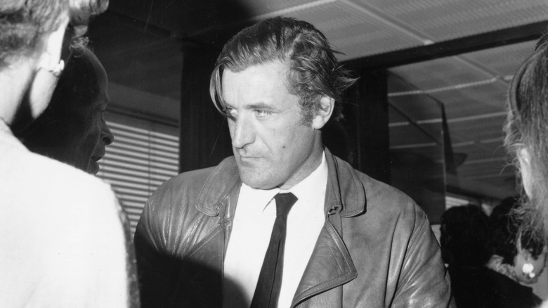 Ted Hughes moves through the crowd