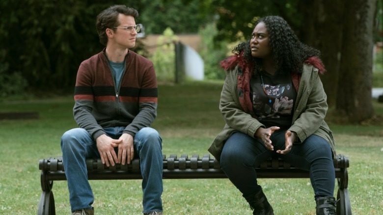 Freddie Stroma and Danielle Brooks talking on bench outside