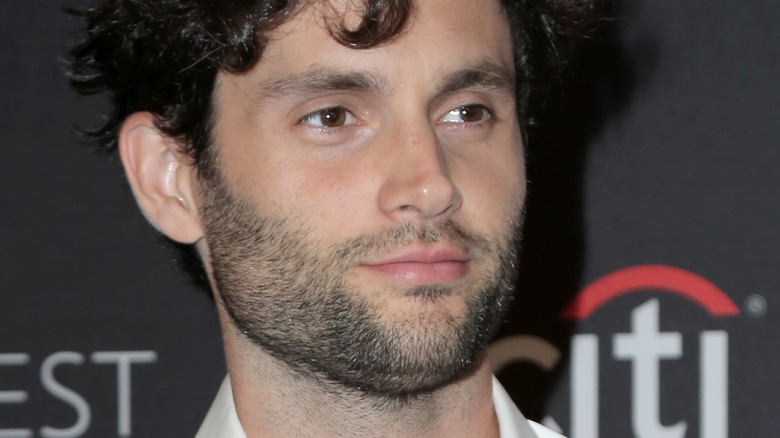 Penn Badgley smiling faintly