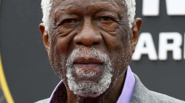 Bill Russell wearing a lavender shirt