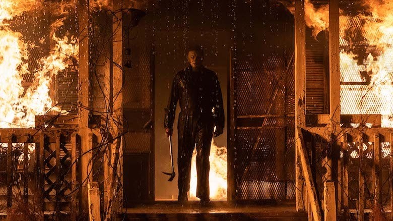 Michael Myers standing in burning house