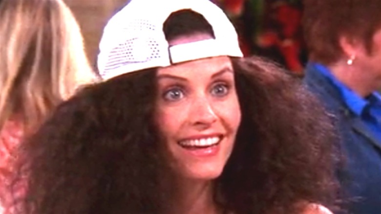 Courteney Cox Monica Geller white hat frizzy hair