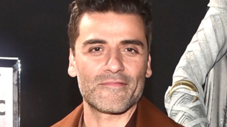 Oscar Isaac wearing brown