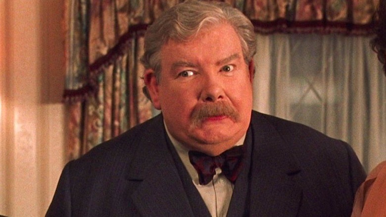 Mr. Dursley frowns arches eyebrow