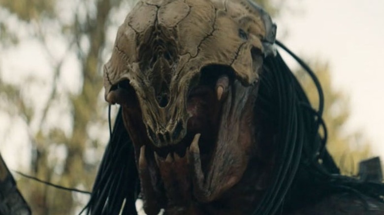 Predator snarling in a mask
