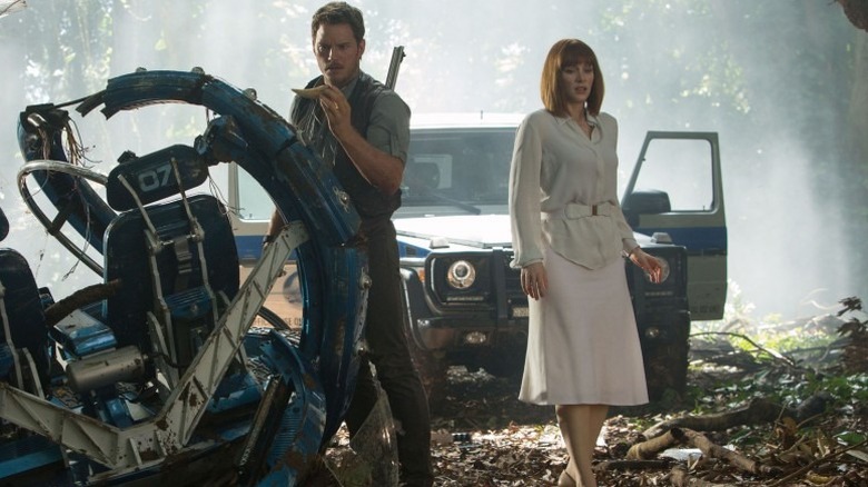 Owen and Claire survey a crash site in "Jurassic World" (2015)