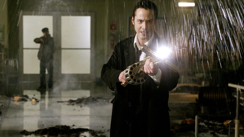 John Constantine pointing a gun with a light in "Constantine" (2005)