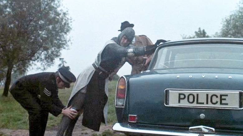 Sir Lancelot getting frisked on a police car in Monty Python and the Holy Grail (1975)