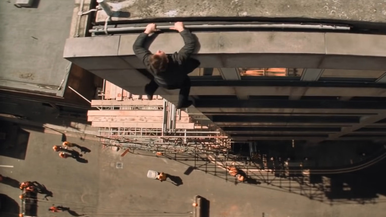 Ethan Hunt hanging from side of building