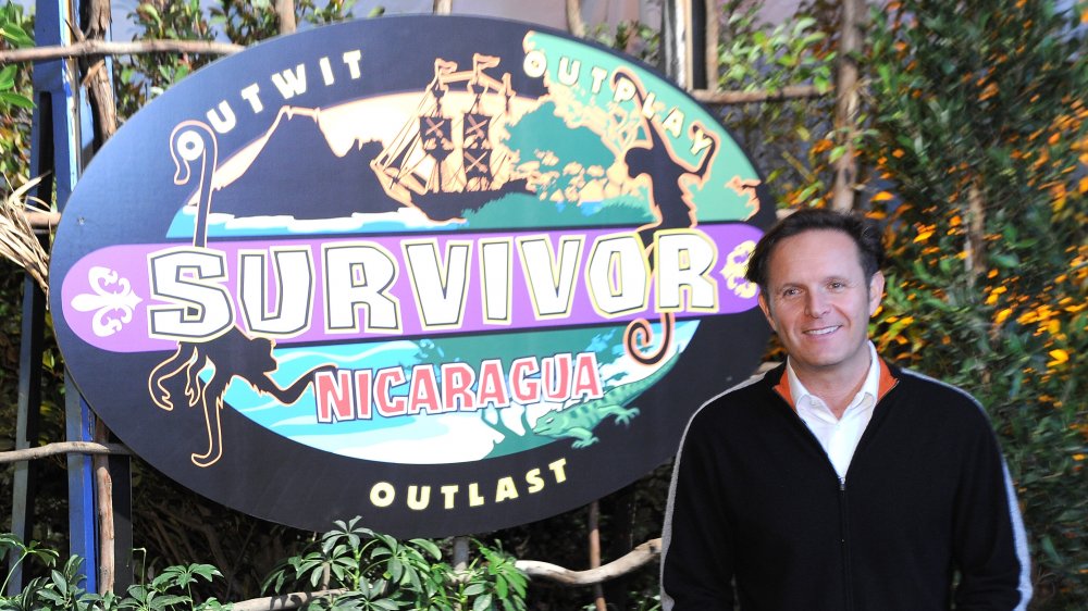 Mark Burnett next to Survivor logo