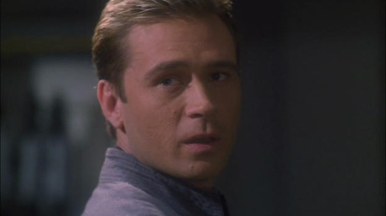 Sim lays in a coffin