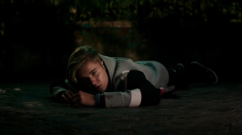 Justin Bieber lying on pavement