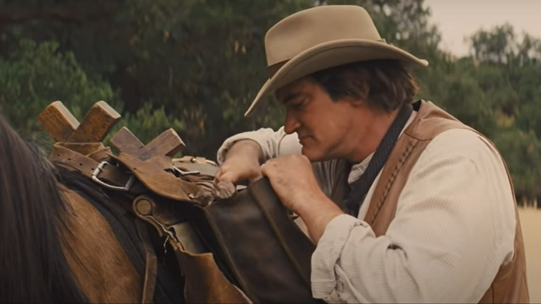 Tarantino miner rifling through saddlebag