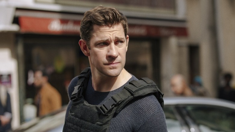 John Krasinski stands on a street as Jack Ryan