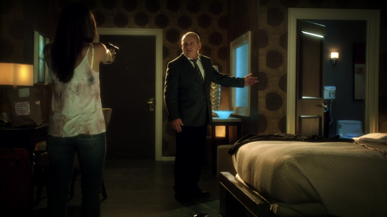 Ellie Brass pointing a gun at her father Jim