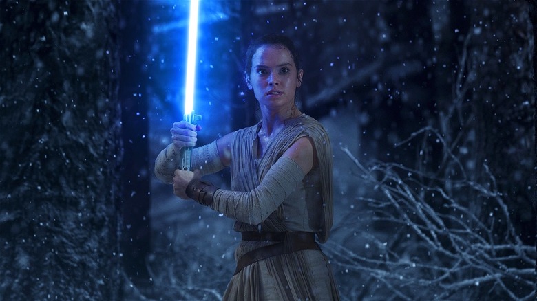 Rey with lightsaber