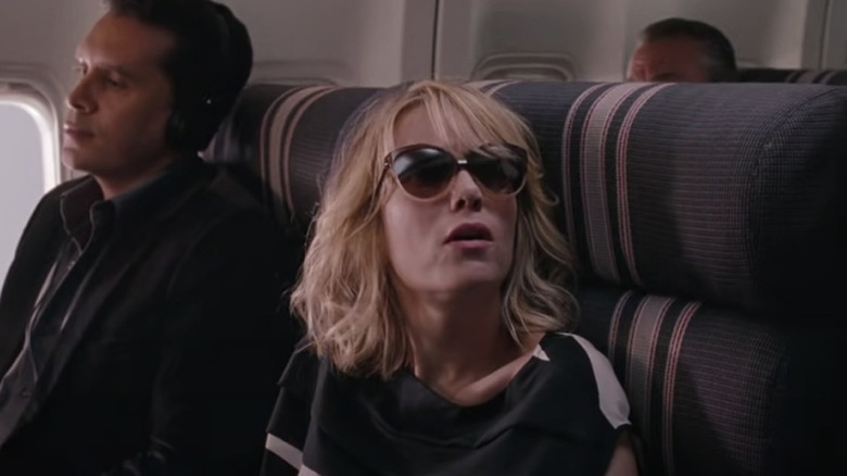 Concerned Kristen Wiig looks up in seat