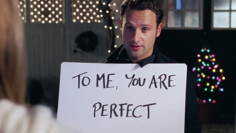 Andrew Lincoln holds up hand-written sign