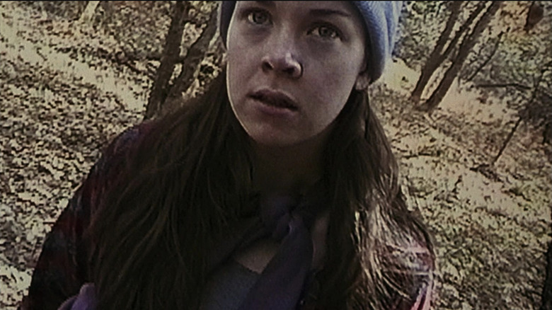 Heather Donahue looking stressed out in the woods