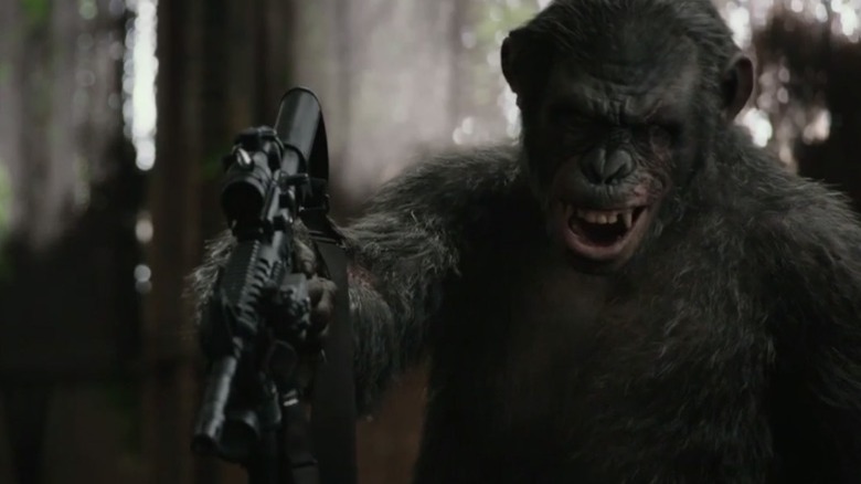Koba holding man at gunpoint