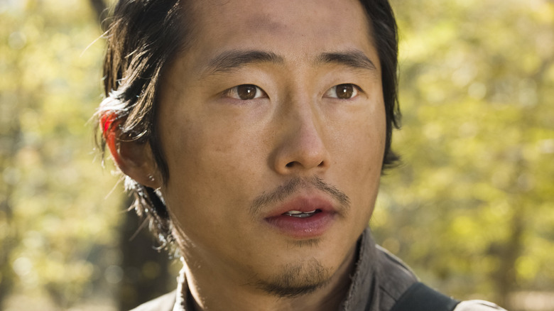 Glenn Rhee staring in forest