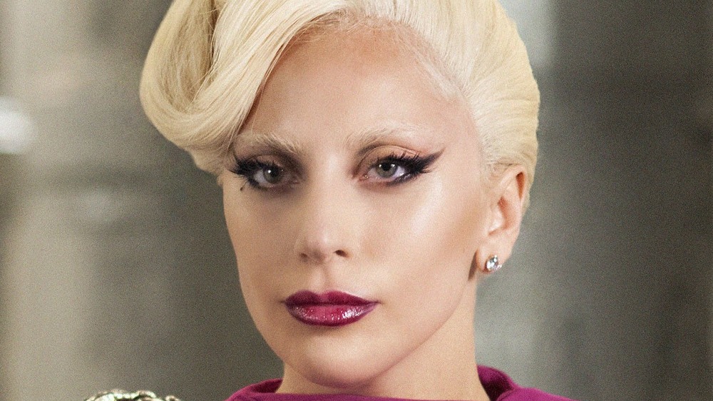 The Countess wearing purple lipstick