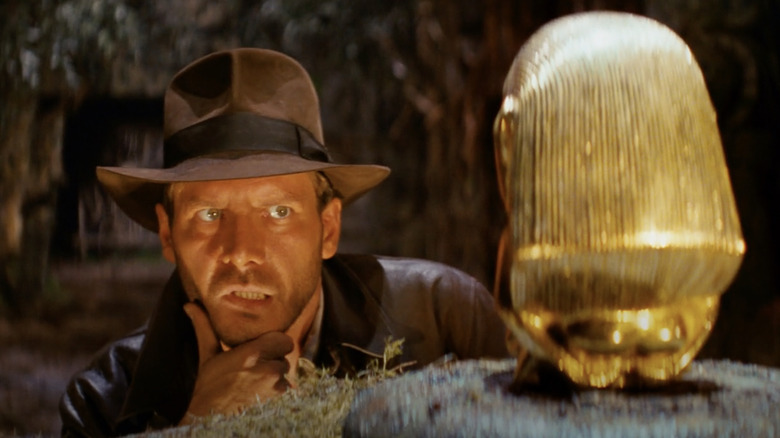 Indiana Jones stares down the golden statue