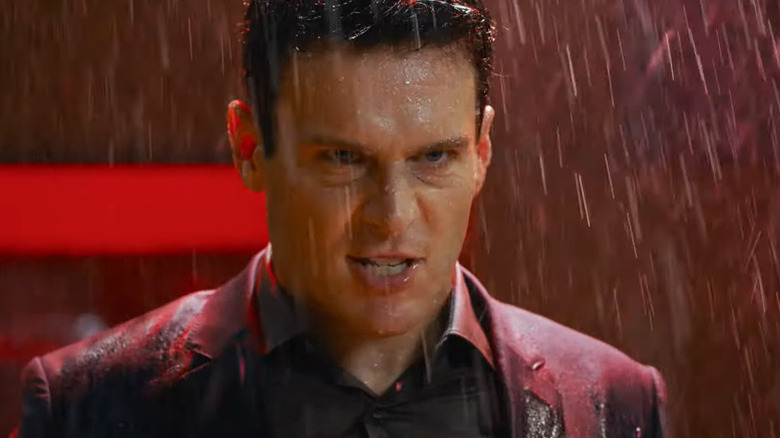 Agent Smith grimacing in the rain