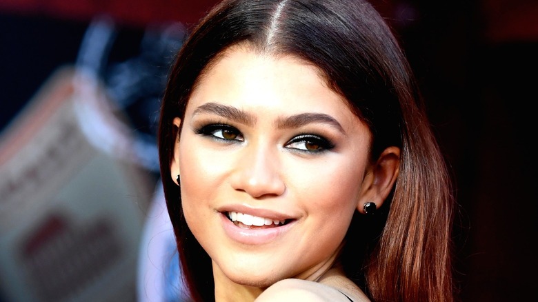 Zendaya smiling at a red carpet event