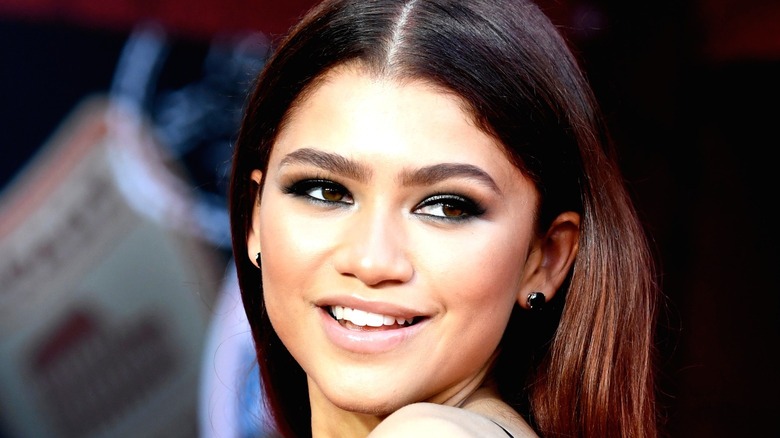 Zendaya smiling at a red carpet event
