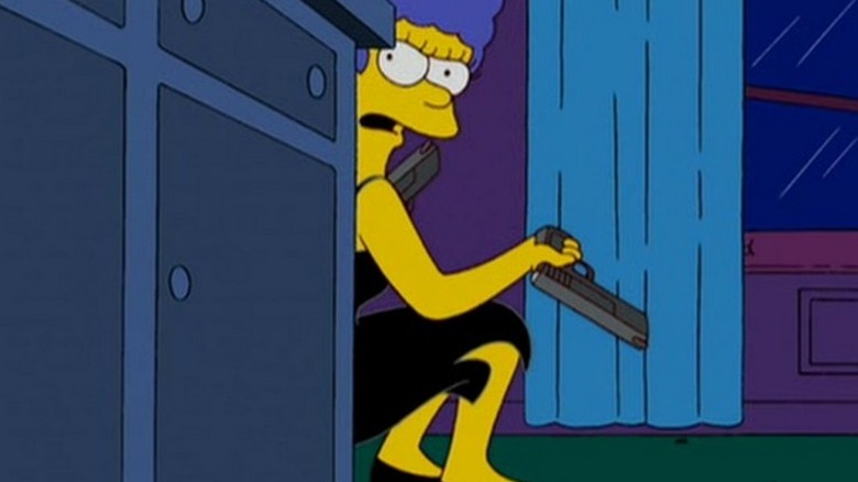 Marge Simpson ducking behind a counter and holding two guns in "Treehouse of Horror XVIII" (2007)