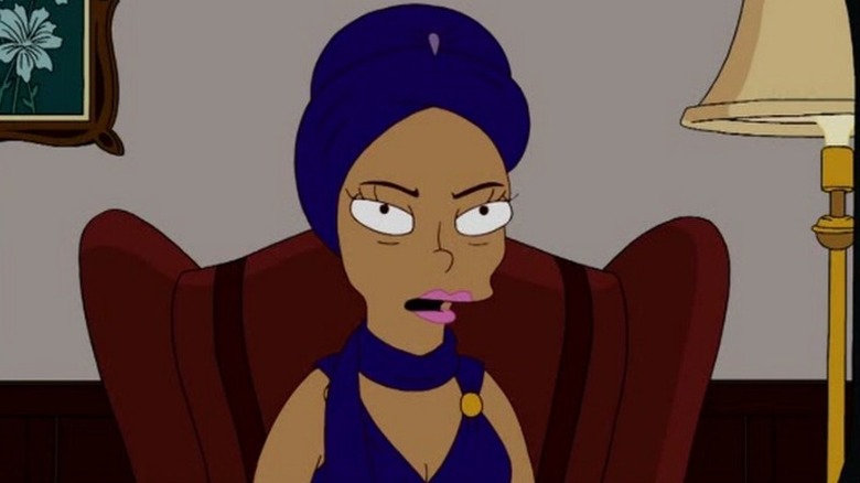 A TV screen showing Eartha Kitt sitting on an armchair and addressing the camera in "Once Upon a Time in Springfield" (2010)