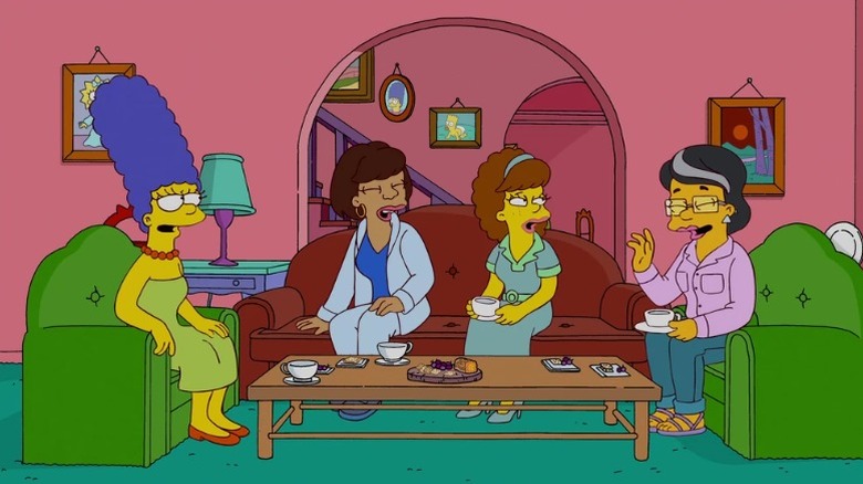 Marge Simpson talking to the other Cool Moms in her living room in "Moms I'd Like to Forget" (2011)