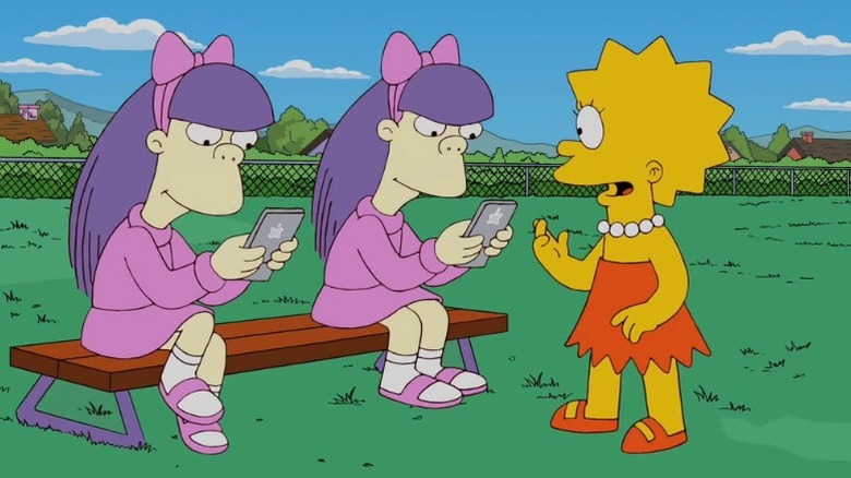 Lisa Simpson talking to Sherri and Terri Mackleberry on the schoolyard in "The D'oh-cial Network" (2012)