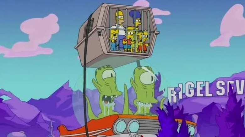 Kang and Kodos carrying the Simpsons in a cage strapped to their flying car in Rigel 7 in "The Man Who Came to Be Dinner" (2015)