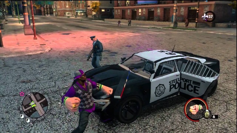 A man punches a police car