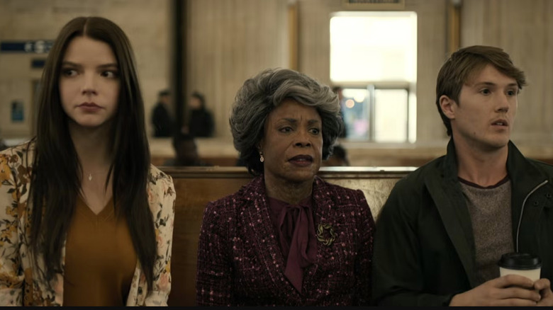 Casey, Mrs. Price, and Joseph sit in a train station in "Glass" (2019)