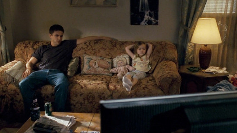 Patrick and Amanda sit on the couch in "Gone Baby Gone" (2007)