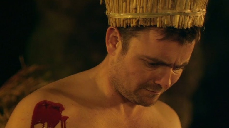 A naked Jay looks down in confusion in "Kill List" (2011)