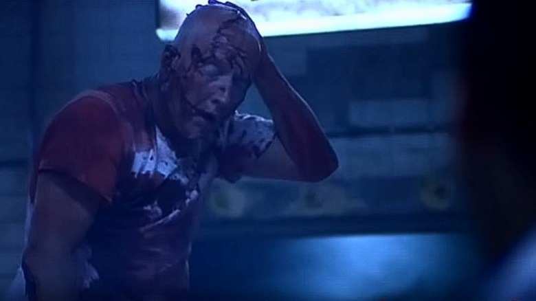 John Kramer/Jigsaw stands up in "Saw" (2004)