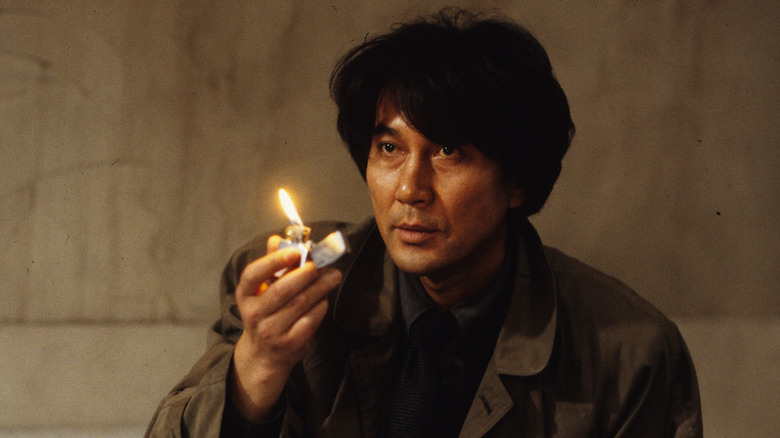 Koji Yakusho holding lighter