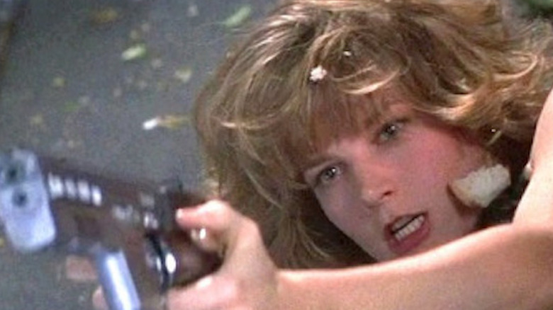 Maggie points a gun
