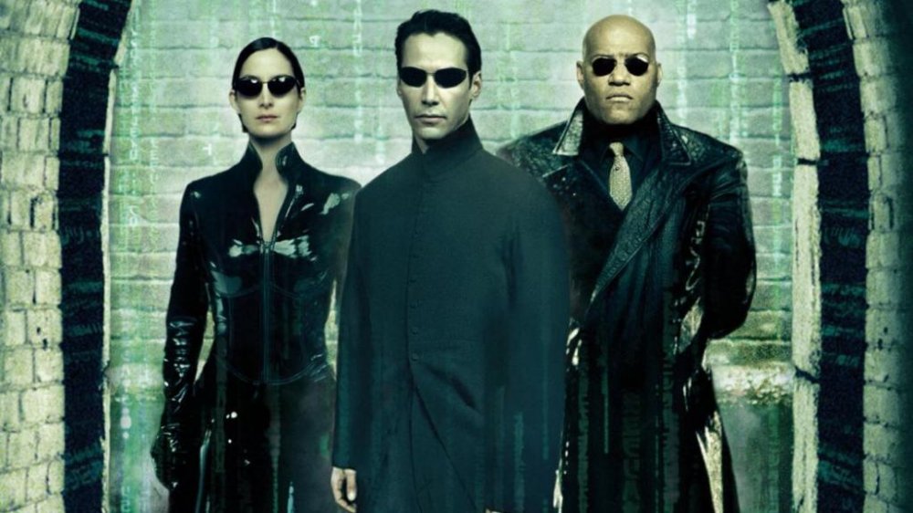 Carrie-Ann Moss, Keanu Reeves, and Lawrence Fishburne as Trinity, Neo, and Morpheus in The Matrix